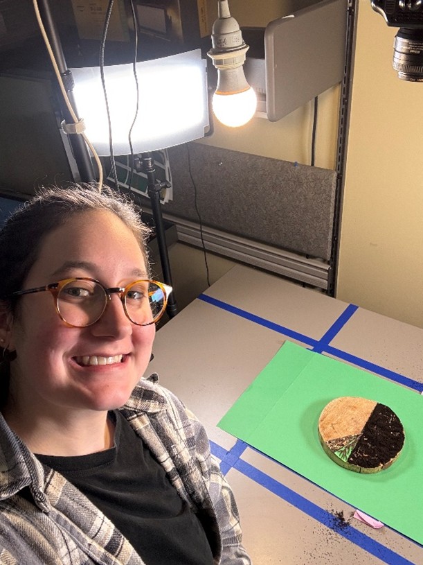 Selfie of Emma with animation setup behind her.