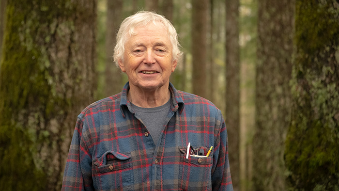 Forestland owner standing in his forest